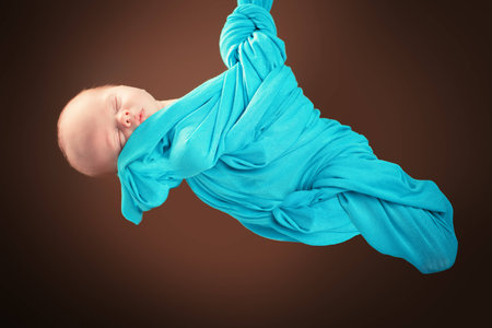 Sweet sleeping baby wrapped in a blanket. Baby care, healthcare.の写真素材