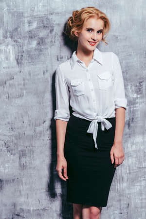 Beautiful young business woman smiling at camera. Fashion, business style.の写真素材