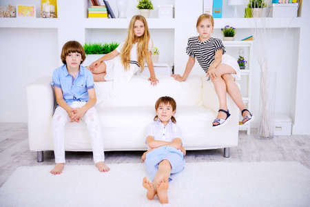 Four cute children spend time together at home. Child concept. Kid's fashion.の写真素材