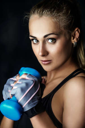 Beautiful athletic woman doing exercises with dumbbells. Fitness, bodybuilding. Health care.の写真素材