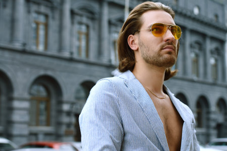 Male fashion. Portrait of a modern handsome man on a city street.