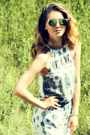 Beautiful young woman in a summer park. Modern hippie, hipster style. Beauty, fashion outdoor.の写真素材