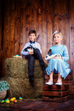 Easter holidays. Happy children posing with Easter Bunny and painted eggs in Easter decorations.の写真素材