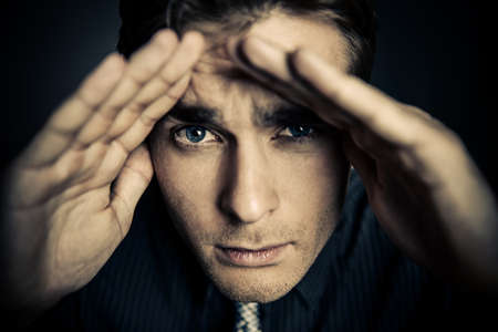 Close-up portrait of a handsome young man in a suit staring into the camera. Business concept. Men's health.の写真素材