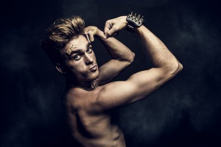 Fight club, MMA. Portrait of a bad guy fighter demonstrating his muscles and strength. Rocker, punk.
