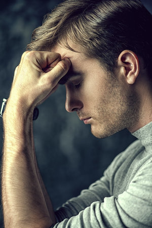 Portrait of a handsome man is thinking hard about something. The power of thought, brainstorming....