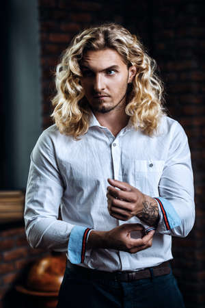 Handsome man in white shirt at home. Business style. Men's beauty, fashion. Hair, hairstyle.の写真素材