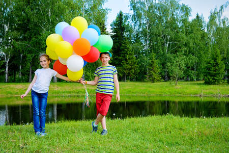 Two children friends spending time together in the park on a sunny day. Summer holidays. Friendship.の写真素材