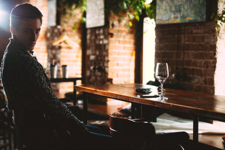 Handsome young man spends time in a wine restaurant.