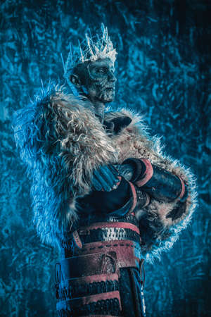 Halloween. The King zombie warrior in the armor of a medieval knight covered with snow. Horror fantasy film.の写真素材