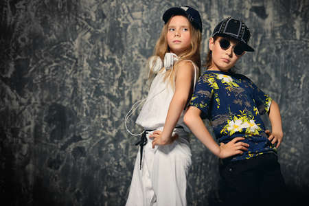 Two cool modern kids posing together in hip-hop style clothes. Children's fashion.の写真素材