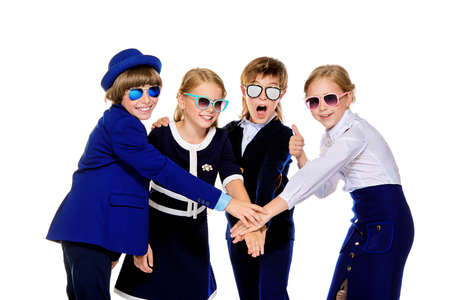 Group of modern children posing in school uniform and sunglasses. School fashion. Isolated over white background.の写真素材
