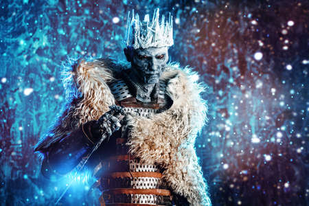 Halloween. The King zombie warrior in the armor of a medieval knight covered with snow. Horror fantasy film.の写真素材
