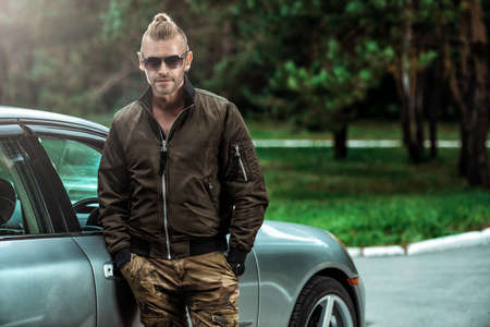 Portrait of a handsome mature man near his car.の写真素材