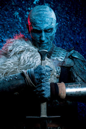 Halloween. Frozen snow covered zombie warrior in the armor of a medieval knight.の写真素材