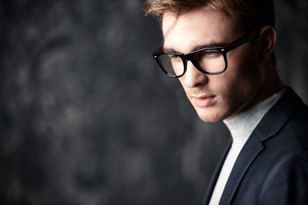 Business concept. Portrait of a handsome businessman wearing suit and glasses.の写真素材