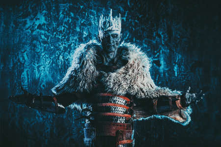 Halloween. The King zombie warrior in the armor of a medieval knight covered with snow. Horror fantasy film.の写真素材