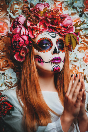 Dia de los muertos. Day of The Dead. Woman with sugar skull makeup on a floral background. Calavera...