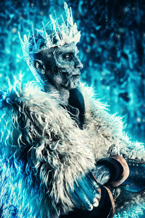 Halloween. The King zombie warrior in the armor of a medieval knight covered with snow. Horror fantasy film.の写真素材
