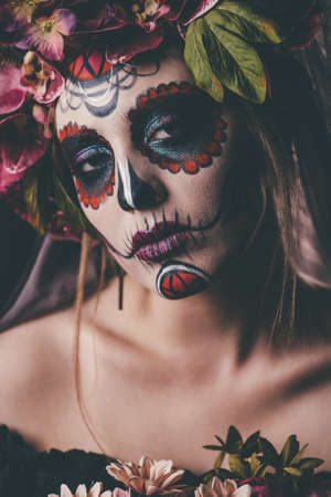 Closeup portrait of Calavera Catrina. Young woman with sugar skull makeup. Dia de los muertos. Day of The Dead. Halloween.の写真素材