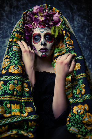 Closeup portrait of Calavera Catrina. Young woman with sugar skull makeup. Dia de los muertos. Day...