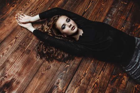 Beautiful girl with long curly hair. Beauty, fashion. Healthy hair, haircare cosmetics.の写真素材