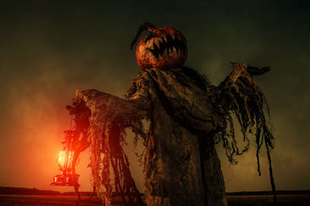 Portrait of a scary Jack-lantern with a pumpkin on his head. Halloween legend.の写真素材
