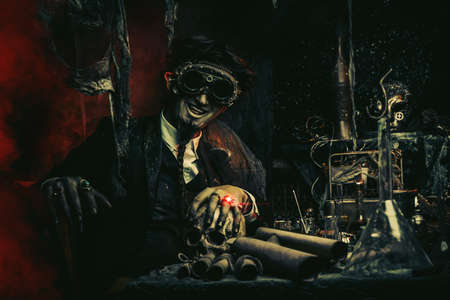 Portrait of a medieval scientist working in his laboratory. Alchemist. Halloween.の写真素材