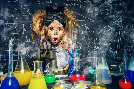 Funny little girl doing experiments in the laboratory. Explosion in the laboratory. Science and...