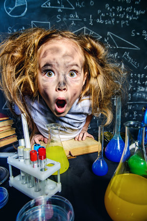 Funny little girl doing experiments in the laboratory. Explosion in the laboratory. Science and...