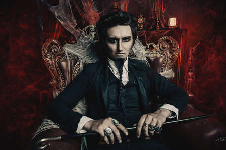 Halloween. Mysterious gloomy man in a black tailcoat in an old abandoned castle. The Dark Lord. Vampire man.の写真素材