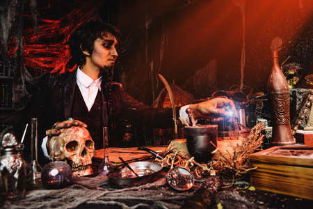 Portrait of a medieval scientist working in his laboratory. Alchemist. Halloween.の写真素材