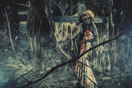 Dead bride woman on an abandoned cemetery. Zombie bride. Halloween.