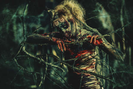 Dead bride woman on an abandoned cemetery. Zombie bride. Halloween.の写真素材