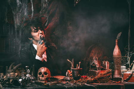 Portrait of a medieval scientist working in his laboratory. Alchemist. Halloween.の写真素材