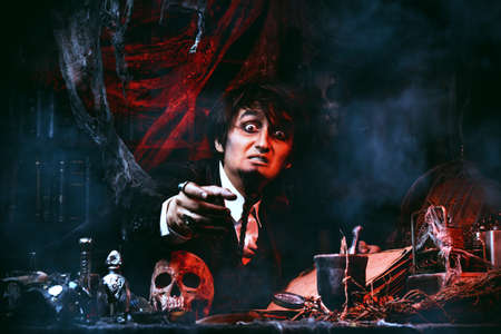 Portrait of a medieval scientist working in his laboratory. Alchemist. Halloween.の写真素材