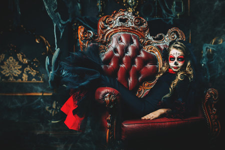 Halloween party. Portrait of a child girl in a costume of Calavera Catrina in the old castle. Little...