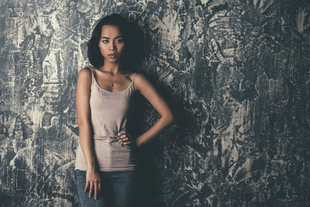 Portrait of a beautiful sensual asian woman over grunge background. Asian beauty. Studio shot.