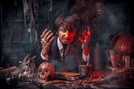 Portrait of a medieval scientist working in his laboratory. Alchemist. Halloween.の写真素材