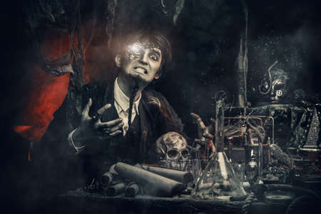 Portrait of a medieval scientist working in his laboratory. Alchemist. Halloween.の写真素材