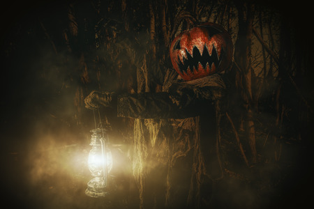 Halloween character. A terrible Jack-lantern with a pumpkin on his head wanders through the night forest.の写真素材
