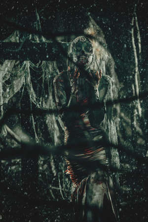 Dead bride woman on an abandoned cemetery. Zombie bride. Halloween.の写真素材