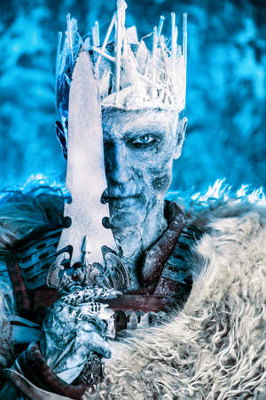 Halloween. The King zombie warrior in the armor of a medieval knight covered with snow. Horror fantasy film.の写真素材