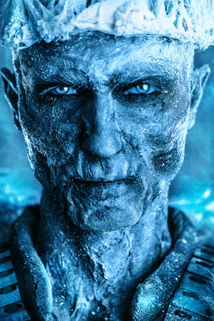 Close-up portrait of The King zombie warrior in the armor of a medieval knight covered with snow. Halloween. Horror fantasy film.の写真素材