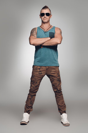 Masculine handsome man in casual clothes posing at studio. Men's fashion. Brutal mature man.