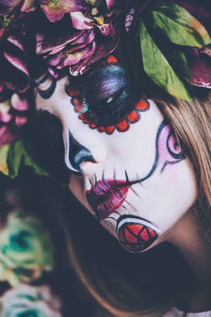 Closeup portrait of Calavera Catrina. Young woman with sugar skull makeup. Dia de los muertos. Day of The Dead. Halloween.の写真素材