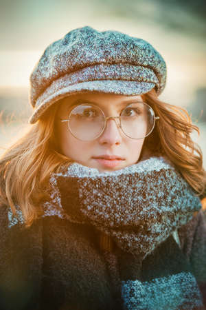 Cute teen girl in modern clothes posing outdoor. Warm autumn day. Seasonal autumn and winter fashion.の写真素材