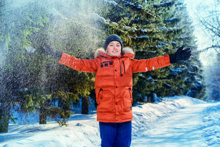 Happy child boy enjoys sunny winter day.の写真素材