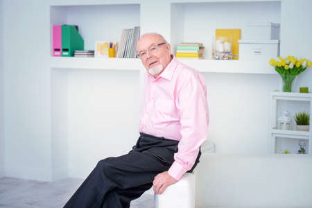 Happy smiling old man having a rest at home. Retirement.の写真素材