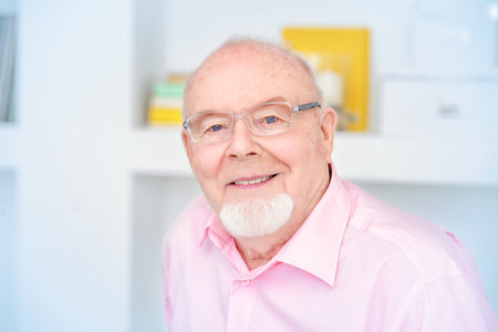 Happy smiling old man having a rest at home. Retirement.の写真素材